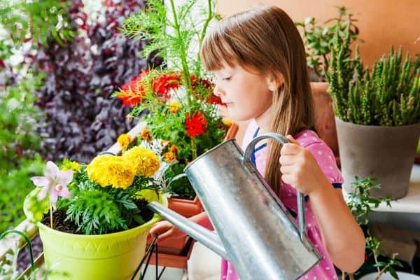 child growing flowers