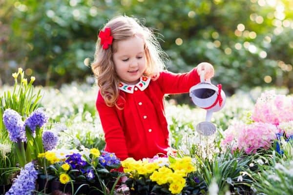 child watering flowers